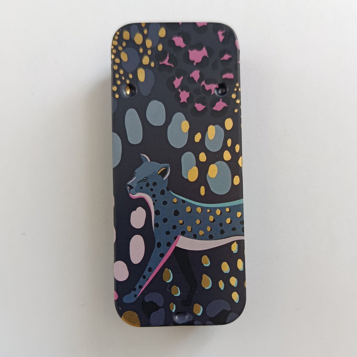 Dark Slider Tin with a Leopard Design and leopard spots across the lid