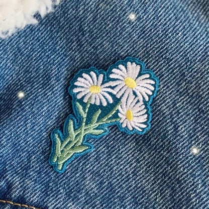 Blue denim jacket with floral patch and white fur lining