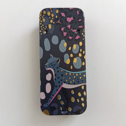 Dark Slider Tin with a Leopard Design and leopard spots across the lid