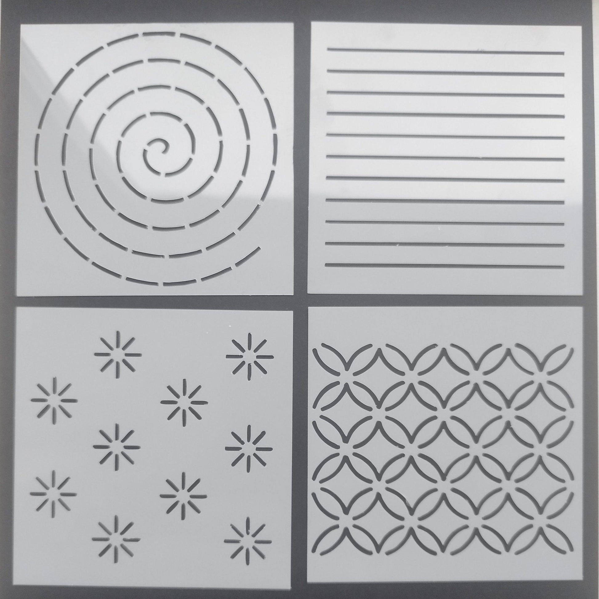 Set of 4 different mending stencils, each with a unique design, displayed against a light background.
