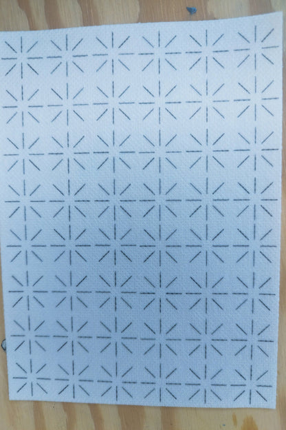 Rectangular sashiko transfer design, with a repeated starburst design. The design has 8 short lines outwards from the centre It is 6 repeats wide and 8 repeats tall. 