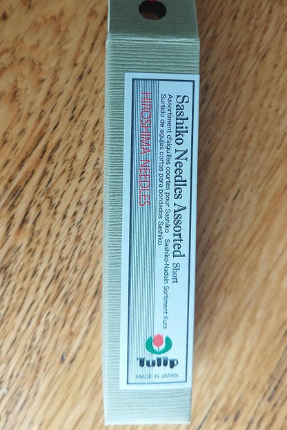 A package of Tulip Hiroshima sashiko needles, showing 6 needles in a cylinder with a cork stopper, labeled for size 0.84mm x 45.