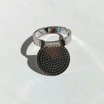 Silver coloured adjustable palm thimble