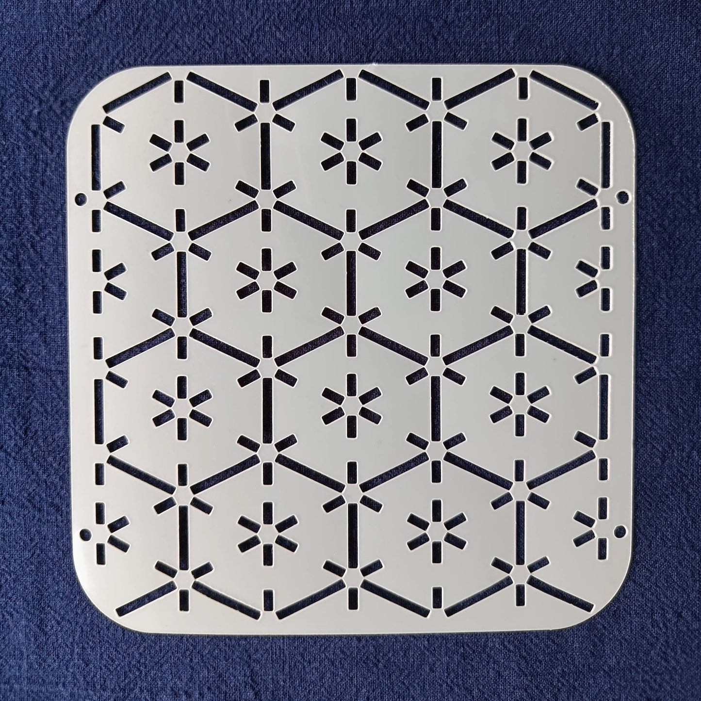 White Stencil of tsuno kikko pattern on a blue background